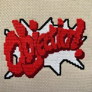 May include: Cross-stitch embroidery of the word "Wicked" in red with a white and black background.