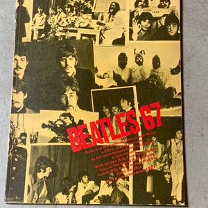 May include: A yellow and black book cover with the title "Beatles 67" in large, bold letters. The cover features a collage of black and white photos of the Beatles. The text on the cover reads "Book 5 of the collected Words and Music, written, played and sung by the most famous Group of all time. In this volume: With A Little Help From My Friends, Lucy in the Sky With Diamonds, Lovely Rita, Hello Goodbye, and 18 more hits from 1967."