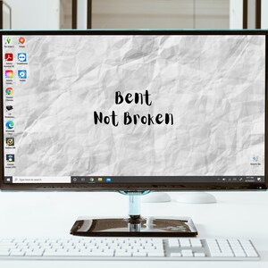 May include: A computer monitor with a crumpled paper background and the text "Bent Not Broken" displayed on the screen.