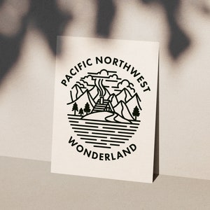 Può includere: Illustrazione in bianco e nero a linee di una catena montuosa con una capanna e fumo che esce dal camino. Il testo "PACIFIC NORTHWEST WONDERLAND" è scritto in un cerchio attorno all'immagine.