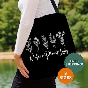 May include: Black tote bag with white floral illustrations and the text "Native Plant Lady".