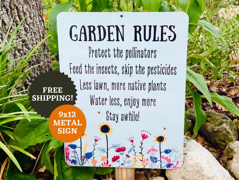 May include: A white metal sign with the text "GARDEN RULES" and a list of rules for gardening, including "Protect the pollinators", "Feed the insects, skip the pesticides", "Less lawn, more native plants", "Water less, enjoy more", and "Stay awhile!" The sign is decorated with colorful flowers and a bee. The sign is 9x12 inches and is made of metal.