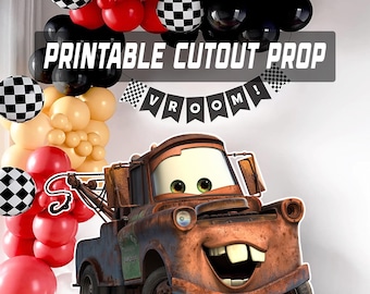May include: A printable cutout prop featuring a cartoon tow truck with a rusty brown finish and a smiling face. The image includes a balloon arch in red, black, and cream colors, along with checkered balloons and a banner that reads "VROOM!"