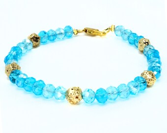 6mm Light Blue Glass Crystal with gold spacer beads, beaded bracelet. Gold clasp.