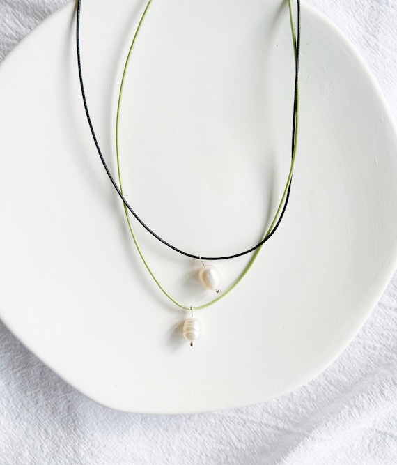 Single pearl necklace on black cord shop