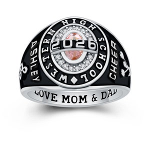 May include: A black and silver class ring with a pink stone and the inscription "Ashley Western High School Cheer 2026" and "Love Mom & Dad".