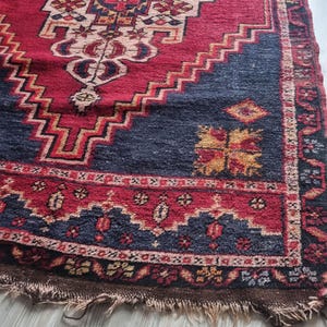 Close-up of intricate floral motifs and fine wool texture on this antique Turkish rug.