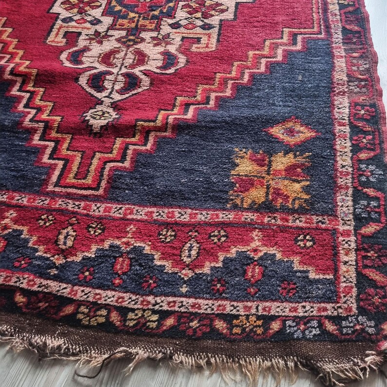 Close-up of intricate floral motifs and fine wool texture on this antique Turkish rug.