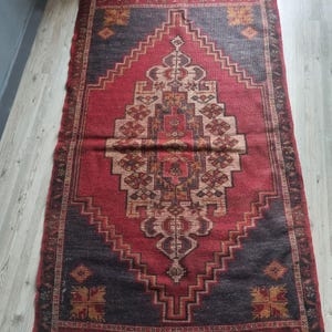 Antique Ottoman rug, preserved over generations, featuring vibrant colors and traditional weaving techniques.