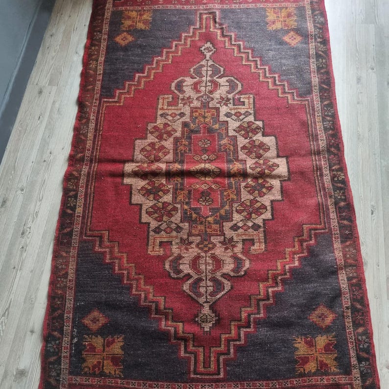 Antique Ottoman rug, preserved over generations, featuring vibrant colors and traditional weaving techniques.