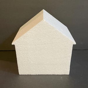May include: White polystyrene house shape for crafting projects. The house is blank and ready to be decorated.