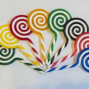 8 Swirl Lollipops For Embellishments or Ornaments. 5”X 2”. Set of 8 different colors. Made of Plastic. Comes with a clear filament hanger.