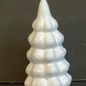 May include: White styrofoam Christmas tree with a textured surface. The tree is shaped like a cone and has multiple tiers.