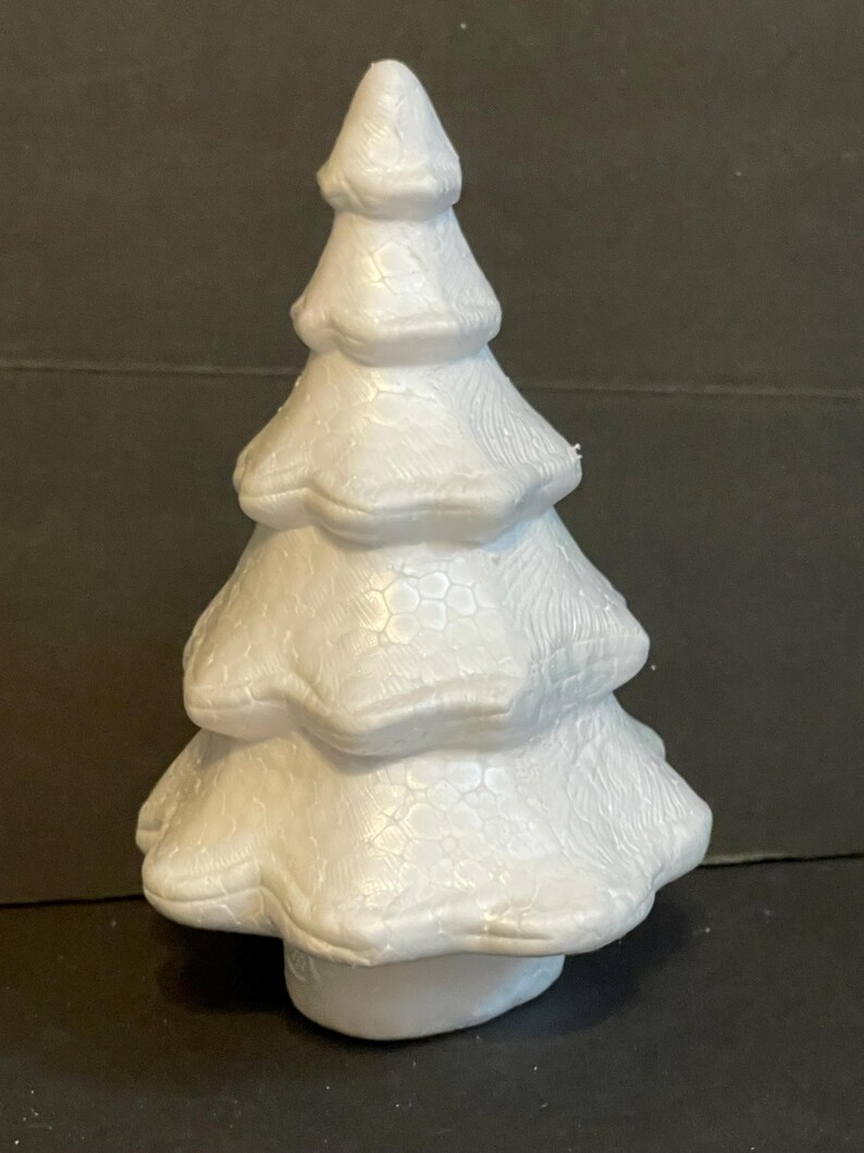 May include: White styrofoam Christmas tree with a textured surface. The tree is approximately 15 cm tall.