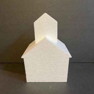 May include: White styrofoam house shaped cake dummy with a pointed roof.
