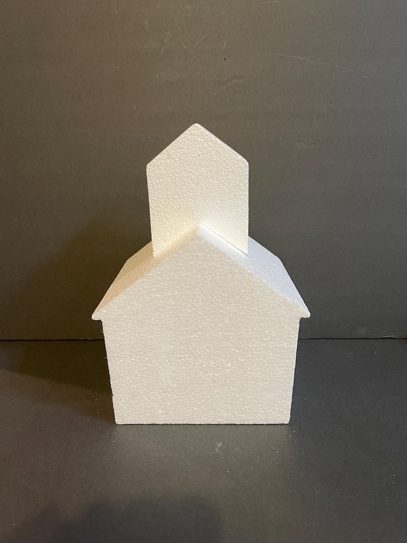 May include: White styrofoam house shaped cake dummy with a pointed roof.