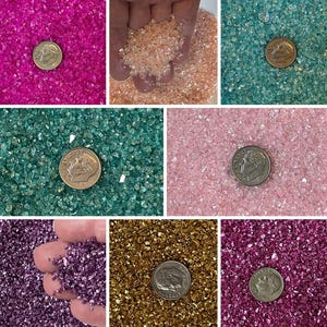 May include: Assortment of iridescent glass glitter in various colors, including pink, teal, gold, purple, and magenta. Each color is shown next to a US dime for scale.
