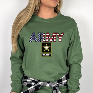 May include: A long-sleeved, military green t-shirt with the word "ARMY" printed in red, white, and blue, with a star and "U.S. ARMY" printed below.