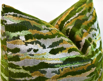 May include: Green velvet pillow with a gold and silver abstract pattern.