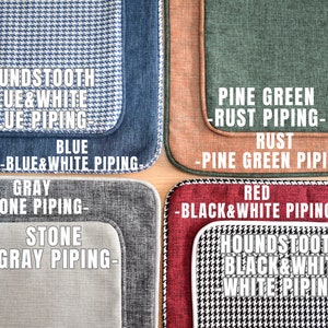 May include: Four different fabric swatches with contrasting piping. The swatches are houndstooth blue and white with blue piping, pine green with rust piping, gray with stone piping, and red with black and white piping.