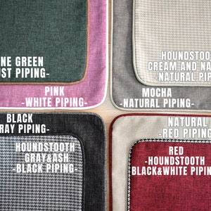 May include: Close-up of fabric samples in various colors and patterns. Includes pine green with rust piping, pink with white piping, black with gray piping, and houndstooth gray and ash with black piping. Other samples include houndstooth cream and natural with natural piping, mocha with natural piping, natural with red piping, and red houndstooth with black and white piping.