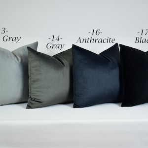 May include: Four decorative throw pillows in various shades of gray, from light gray to black. The pillows are arranged in a row from left to right, with the lightest color on the left and the darkest color on the right. The pillows are labeled with their corresponding colors and numbers: -13- Light Gray, -14- Gray, -16- Anthracite, -17- Black.