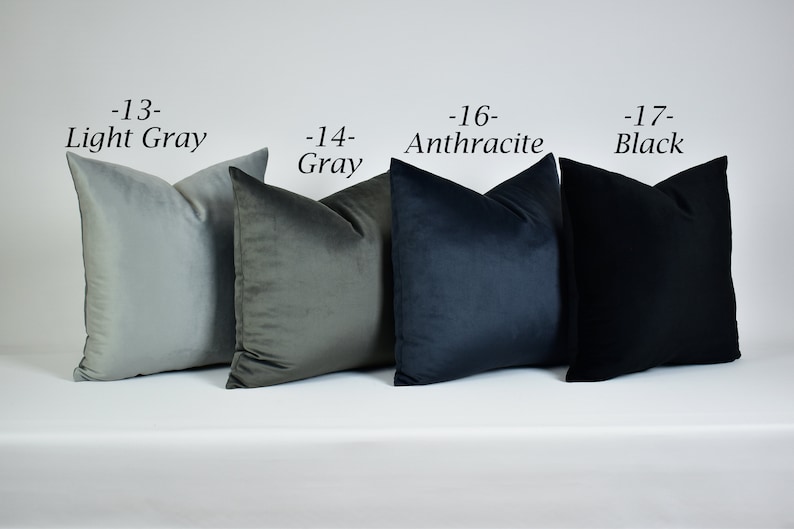 May include: Four decorative throw pillows in various shades of gray, from light gray to black. The pillows are arranged in a row from left to right, with the lightest color on the left and the darkest color on the right. The pillows are labeled with their corresponding colors and numbers: -13- Light Gray, -14- Gray, -16- Anthracite, -17- Black.