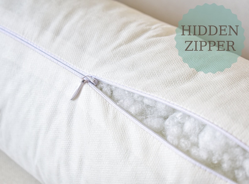 May include: A white pillow with a hidden zipper. The zipper is open, revealing the white filling inside.