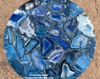 May include: A round blue agate table top with a variety of blue and white agate slices. The table top is made of natural stone and has a unique, organic look. The table top is approximately 30 inches in diameter. www.etsy.shop/royalhandicraftexpo.com