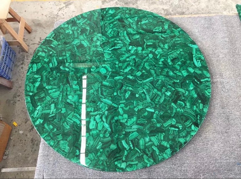 May include: A round green malachite table top with a swirling pattern.