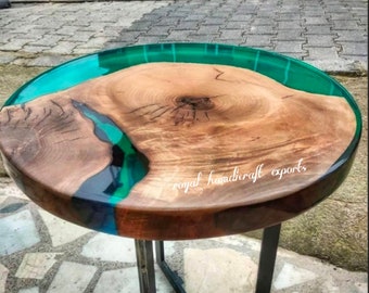 May include: Round wooden table top with a green and blue epoxy resin inlay. The table has a black metal base.