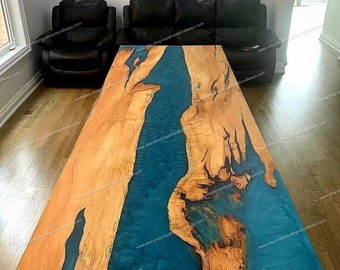 May include: A large wooden table with a teal blue epoxy river running through the center. The table is made of natural wood with a rich grain pattern. The epoxy river is smooth and glossy, with a slight shimmer.