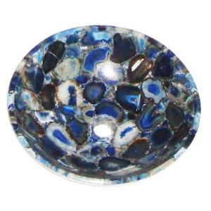 Pode incluir: Uma pia redonda de pedra de ágata azul e branca. A pia é feita de pedras polidas de formato irregular em tons de azul, branco e preto. Possui um orifício de drenagem central e um acabamento liso e brilhante. O design é um padrão de mosaico.
