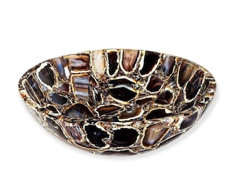 May include: A brown agate stone sink with a unique mosaic design. The sink is made of natural agate and has a smooth, polished finish.