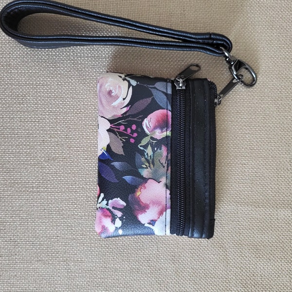 Wristlet/pouch/clutch featuring blue and pink flowers. 2 zippers, removable strap, gunmetal hardware. Great gift item