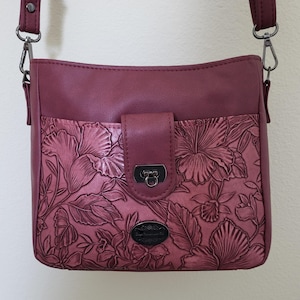 Stunning: embosed floral design and smoooth wine-colored faux leather. Lots of pockets; mid-size purse/shoulderbag/crossbody. 8 x 10 x 4.