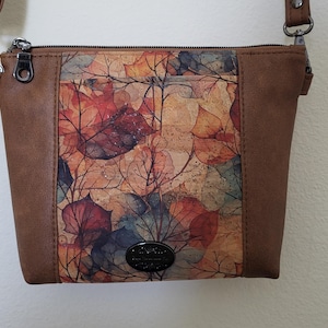 Autumn leaves on cork plus brown faux leather. Lots of pockets on this mid-size purse/shoulderbag/crossbody. A winner. 7 x 9.5 x 2"