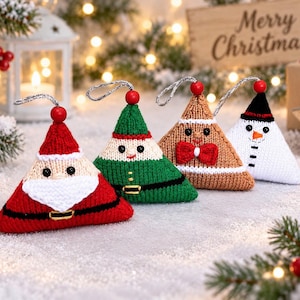 May include: Four triangular knitted Christmas ornaments featuring characters: a red Santa with a white beard, a green elf, a tan gingerbread person with a red bow tie, and a white snowman with a black hat. Each has a red bead and silver hanging loop.
