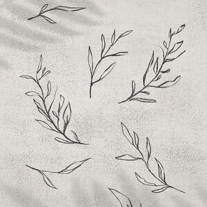 May include: Hand-drawn line leaf wreath design in black on a textured, off-white background. The image features several sprigs of leaves, with the text "Hand Drawn Line Leaf Wreath" and "300dpi 1 PNG FILE". The artist's name, "JULIA x JULIES ART", is also included.