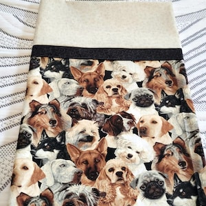 May include: A beige fabric with a black border features a repeating pattern of various dog breeds. The dogs are depicted in a realistic style with detailed fur and facial expressions.