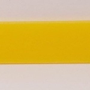 May include: A bright yellow rectangular key tag with a small hole at the top.