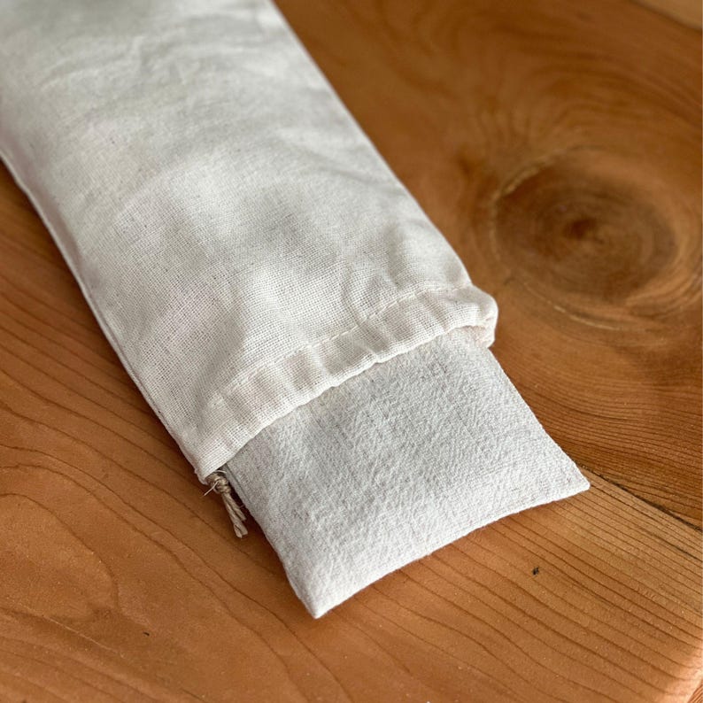 Stack of wholesale lavender eye pillows tied with a ribbon, ready for bulk orders and gift sets.