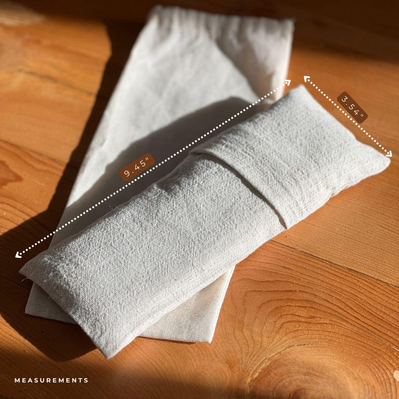 Handcrafted eye pillow with a removable linen cover, elegantly displayed on a cozy meditation space.