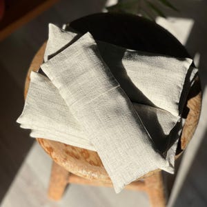 A person resting with the eye pillow over their eyes, enjoying deep relaxation and stress relief.