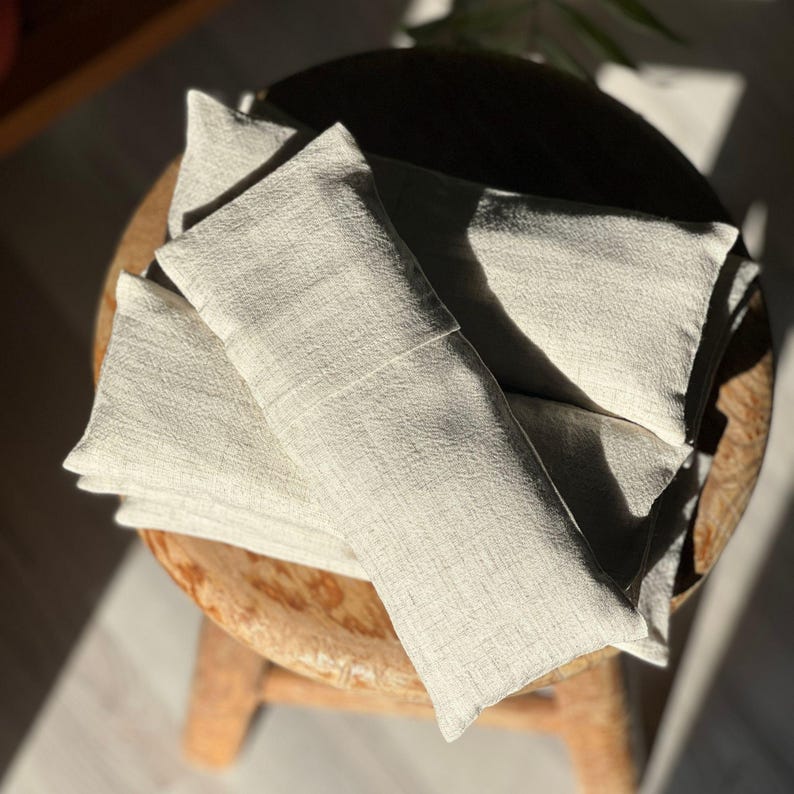 A person resting with the eye pillow over their eyes, enjoying deep relaxation and stress relief.