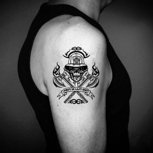 May include: Black and white temporary tattoo of a firefighter skull with crossed axes and flames. The text "First In Last Out" is on a banner.
