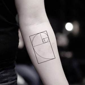 May include: A black and white line drawing of the golden ratio, also known as the Fibonacci spiral, on a person's arm.