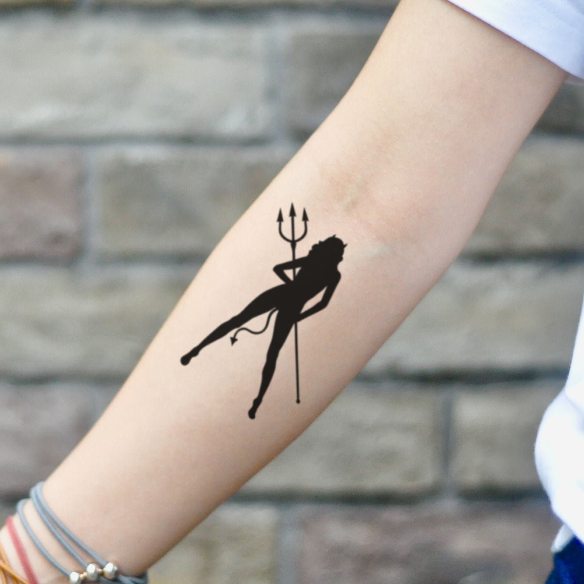 Devil heart tattoo on butt cheek