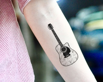 15 Best Guitar Tattoo Designs with Meanings  Guitar tattoo design Music guitar  tattoo Guitar tattoo