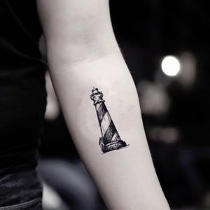 May include: A black and white sketch of a lighthouse with a striped design on the tower.